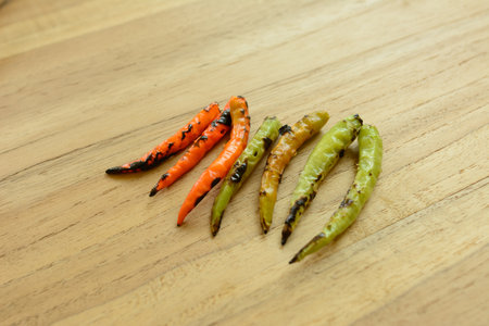grilled chili on wood cutting board prepare cooking close up