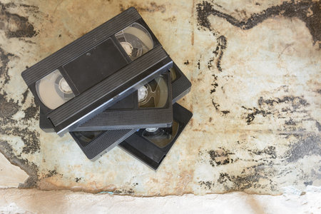 stack of  old vintage dirty vhs video tape on concrete background