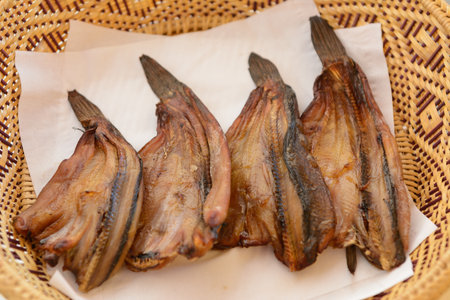 grilled striped snakehead fish  on a rattan basket made with hot oven thai style food close upの写真素材