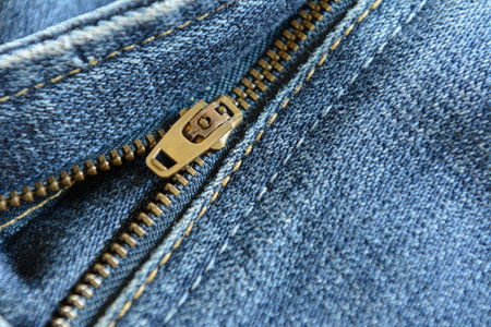 brass zipper of old blue jeansの写真素材