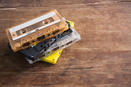 stack of cassette tape, old media record technology on crack and dirty wooden surfaceの写真素材