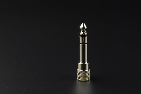 audio stereo jack converter on dark surfaceの写真素材