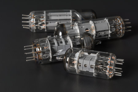 a group of old vacuum tube laying on grey surface, close upの写真素材