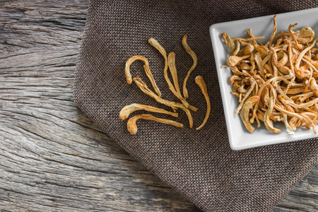 dried cordyceps militaris mushroom with old and crack wooden surface backgroundの写真素材