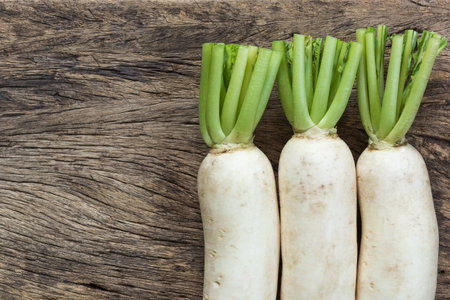 white radish on old and crack wooden surface background, top viewの写真素材