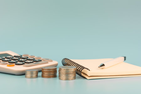 stack of coinà¸« notebook pen and calculator in vintage tone. planning save for concept.