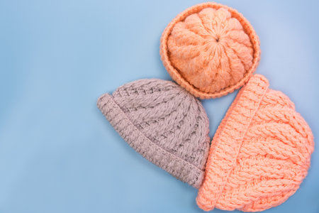 Vintage design winter yarn hat on light blue background, top view.の写真素材
