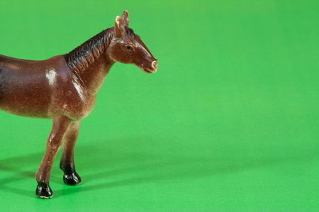 Children's toy horse standing on an artificial green meadowの写真素材