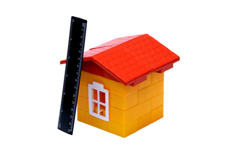 Children's folding model-toy the house with yellow walls from bricks and a red tile roofの写真素材