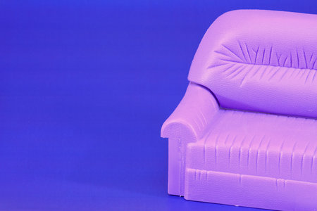 Armchair-sofa toy photographed on a dark blue backgroundの写真素材