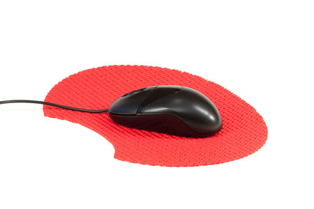 Computer mouse on a red rug. White backgroundの写真素材