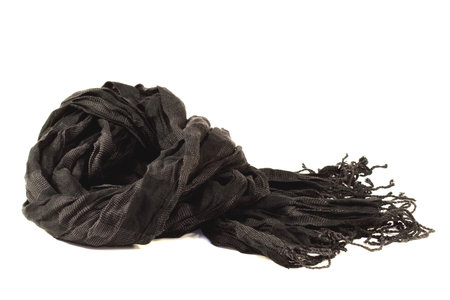 Lightweight black scarf lying on a white backgroundの写真素材