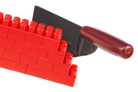 Fragment of a plastic, toy wall and construction tools. Conceptの写真素材