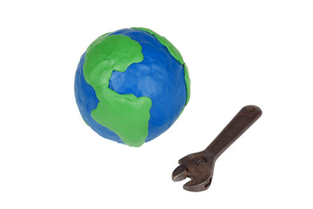 Model of the globe and an old wrench on a white background の写真素材