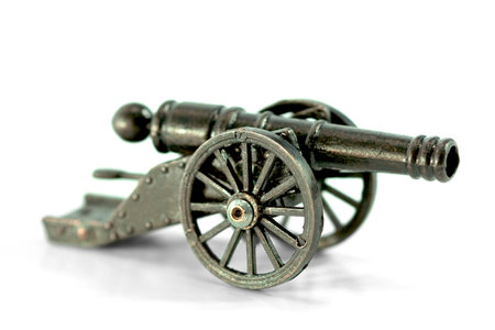 A miniature model of an old cannon on a white background. Close-upの写真素材