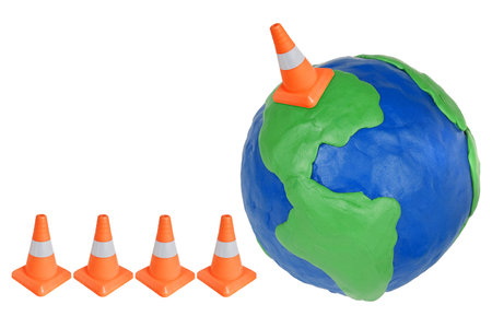 Emergency cone and plasticine globe on white backgroundの写真素材