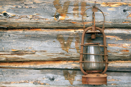 Antique kerosene lamp on the background wall of a village houseの写真素材