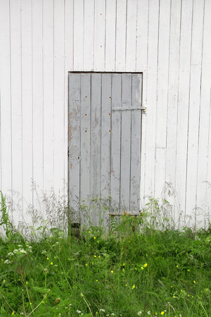 Closed door and wall fragment of the old houseの写真素材