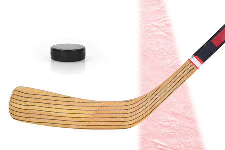 Hockey stick and puck on a white background with a red stripeの写真素材