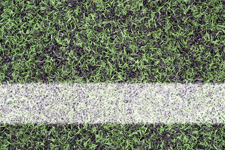 Detail of the cover of artificial sports turf with markings