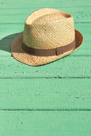Men's straw hat, lying on an old wooden tableの写真素材