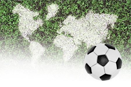 Ball and a fragment covering football pitch with world mapの写真素材