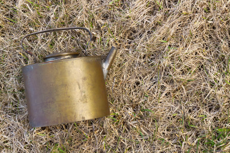 Old camp kettle, lying on the grass. Texture, backgroundの写真素材