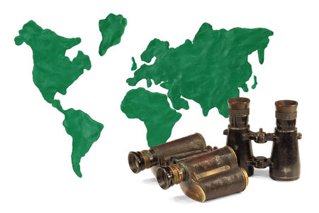Continents and continents made of clay and old binocularsの写真素材