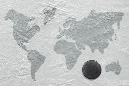 Hockey puck on the ice with the image of a world map
