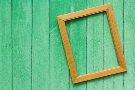 Photographic frame hanging on wooden wall streetの写真素材