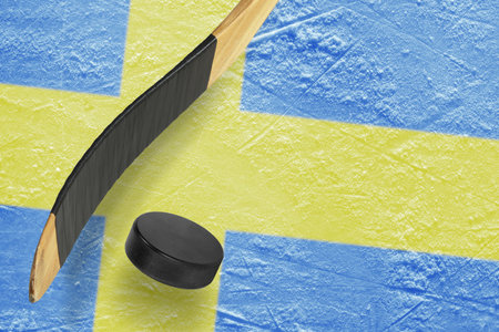 Hockey puck, stick and a fragment of an image of the Swedish flagの写真素材