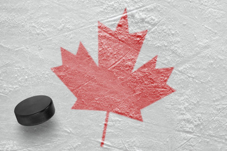 Hockey puck and the image of a maple leaf. Conceptの写真素材