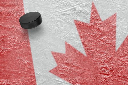 Hockey puck and the image of the Canadian flag. Conceptの写真素材