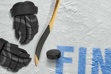 Finnish stick, gloves and puck on the ice arena. Concept