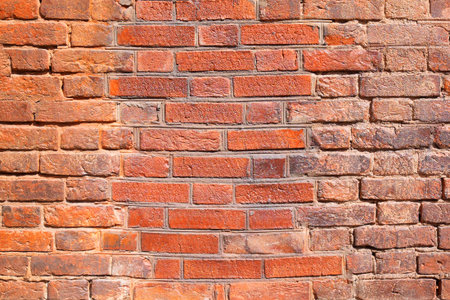 A fragment of the restored old brick wall. Texture, background