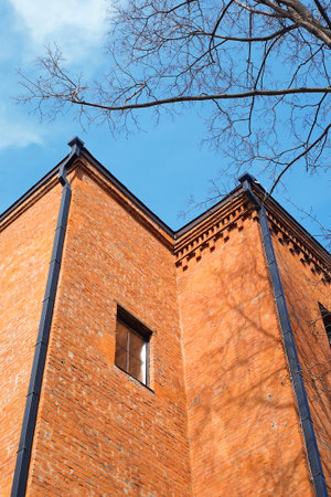 A fragment of the old brick building with wood. Texture, background