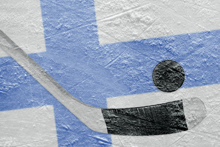 Image Finnish flag and hockey puck with the stick on the ice. Conceptの写真素材