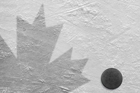 Hockey puck and a schematic representation of the Canadian flag. Conceptの写真素材