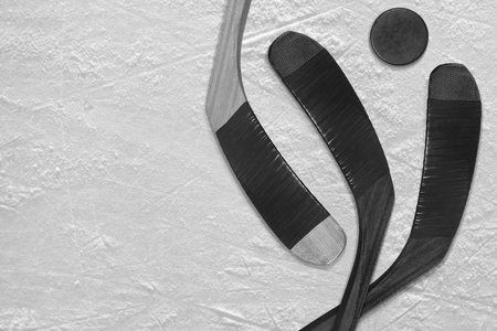 Hockey puck and stick on the three black ice hockey rinkの写真素材