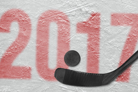 Hockey stick and puck on the ice stadium. Concept, hockey, season 2017