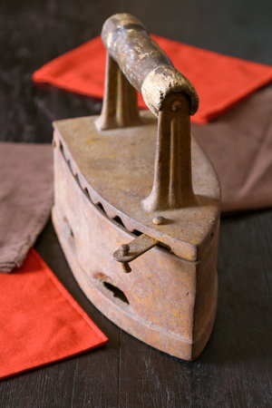 The old iron on a wooden table. Texture, background, still lifeの写真素材