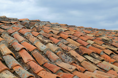 Fragment of an old tiled roof. Architecture, exteriorの写真素材