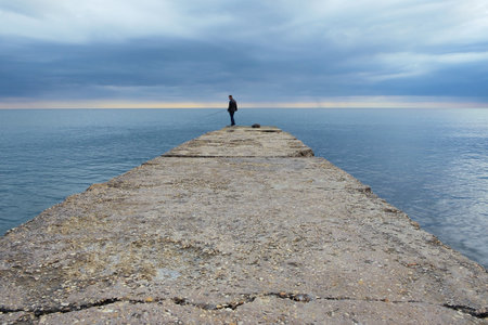 Sea fishing from the pier. Sea, sunset, landscapeの写真素材