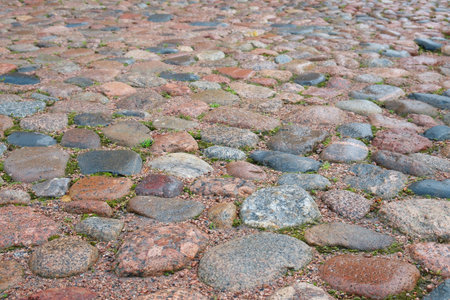 Fragment of an ancient stone pavement in Vyborg. Background, texture, architecture