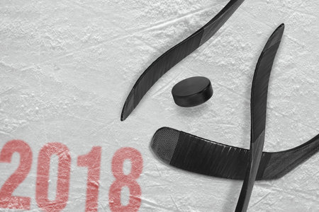 Hockey sticks and washer on the ice of the sports arena. Concept, hockey, season 2018の写真素材