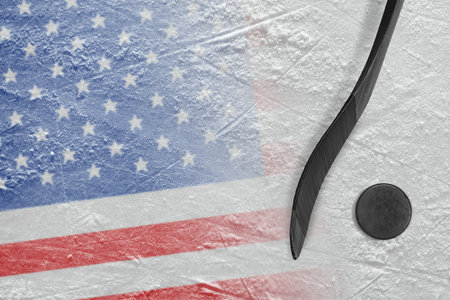 Hockey puck, stick and the image of the American flag on the ice. Concept, hockeyの写真素材