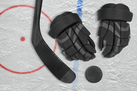 Hockey stick, gloves and washer in the ice arena. Concept, hockey, seasonの写真素材