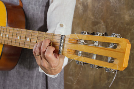 Fragment of a guitar close up while playing
