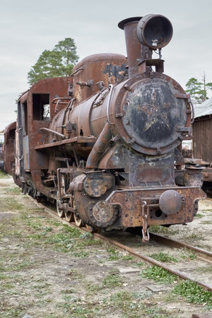 Defective steam locomotive and a fragment of the old railwayの写真素材