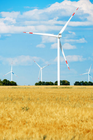 Wind power generator in a wheat field. technology, summer landscape